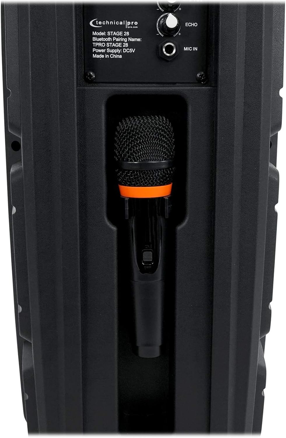 Close-up of the speaker's rear panel showing the microphone storage compartment with a microphone inserted.