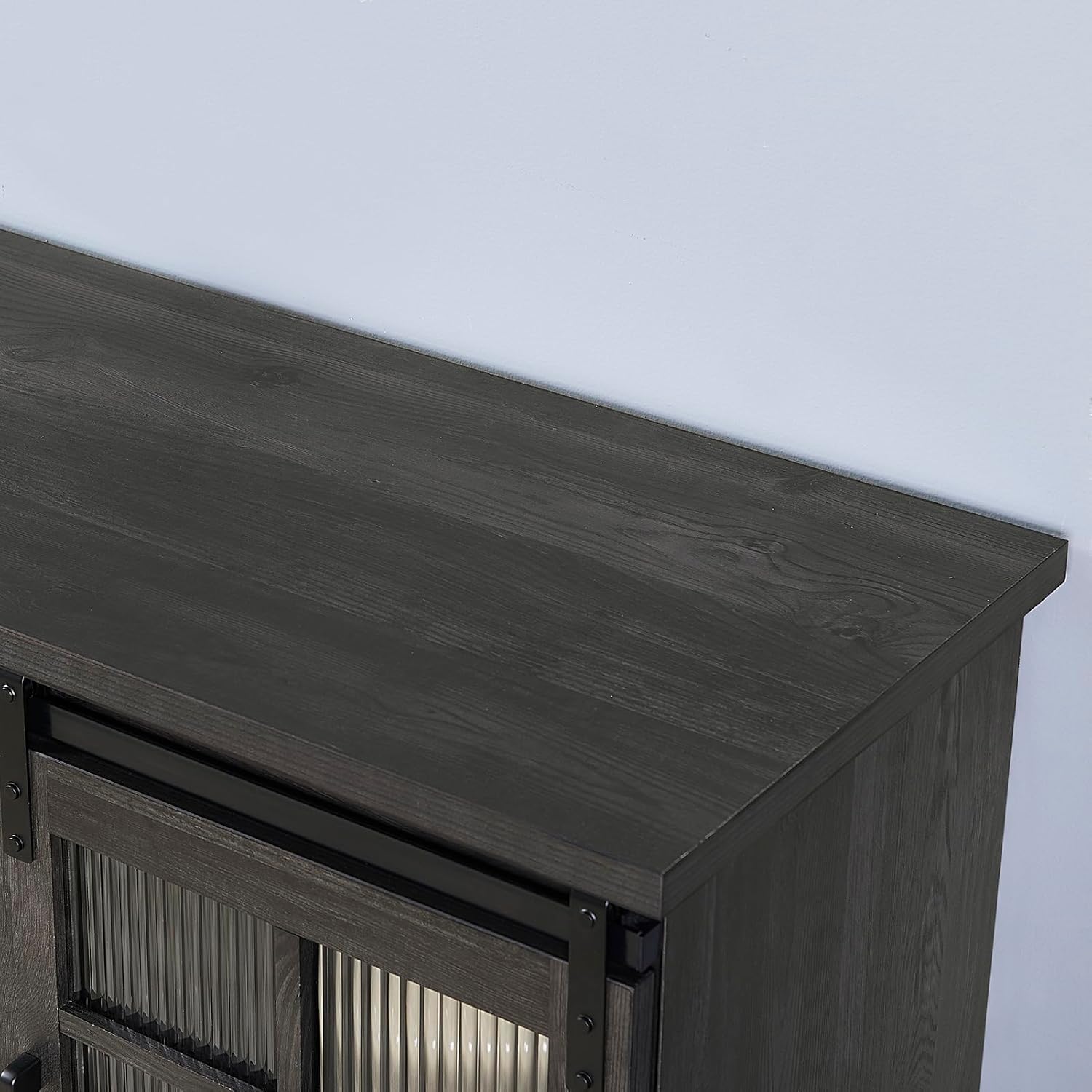 Close-up of the TV stand's top surface showing wood grain texture