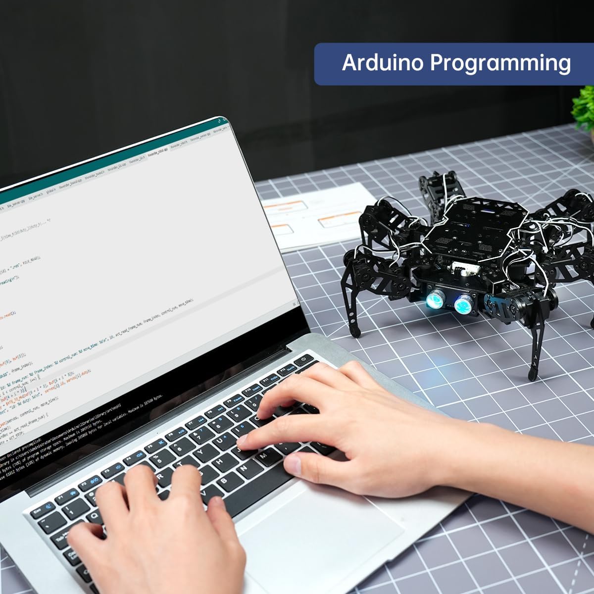 A person programming the miniHexa robot using Arduino IDE on a laptop