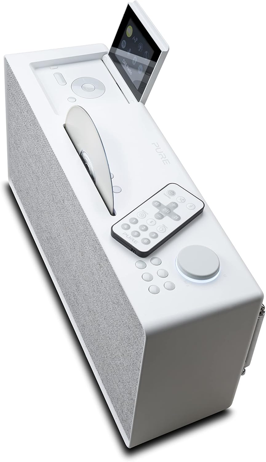 Angled top view of Pure Evoke Home showing the remote control, CD slot, and top panel buttons.