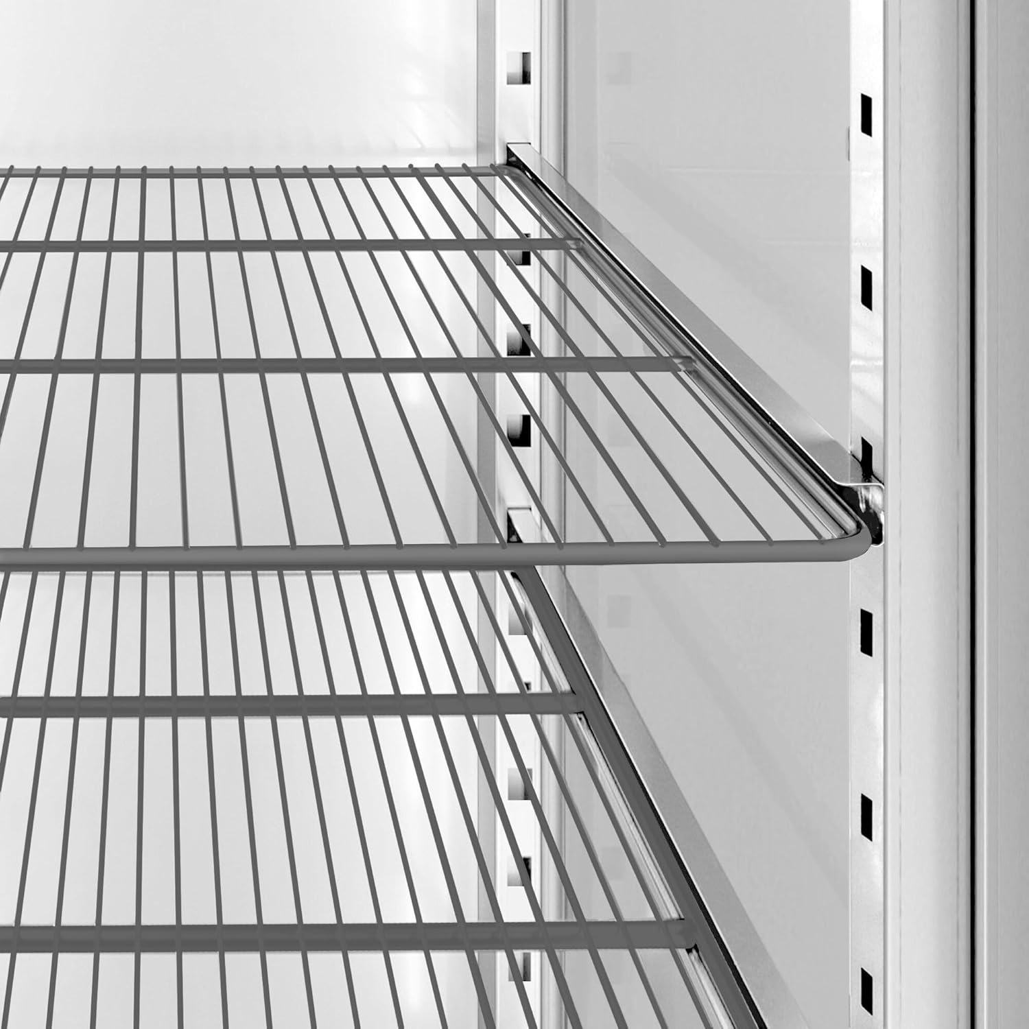 Close-up of the adjustable wire shelves inside the GGM Gastro freezer, showing the support rails.