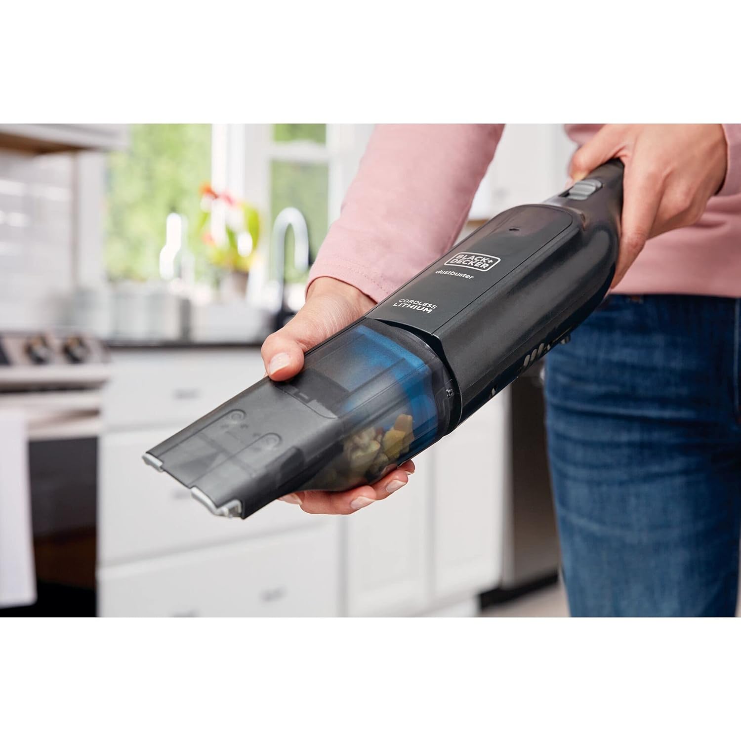 Hand removing the dust bowl from the BLACK+DECKER HLVC320J11-QW vacuum cleaner