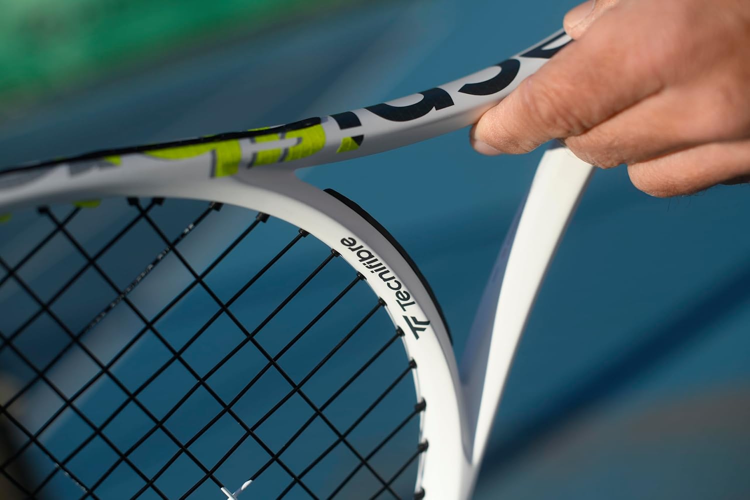 Close-up of a hand holding the Tecnifibre TF-X1 275 tennis racket handle