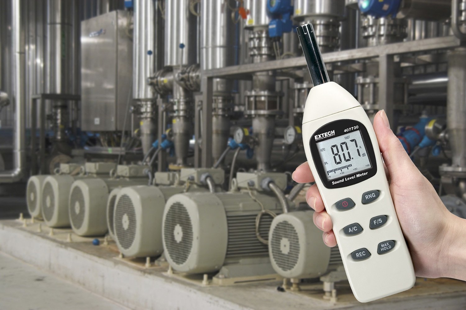 Extech 407730 Digital Sound Level Meter in use in an industrial setting with machinery