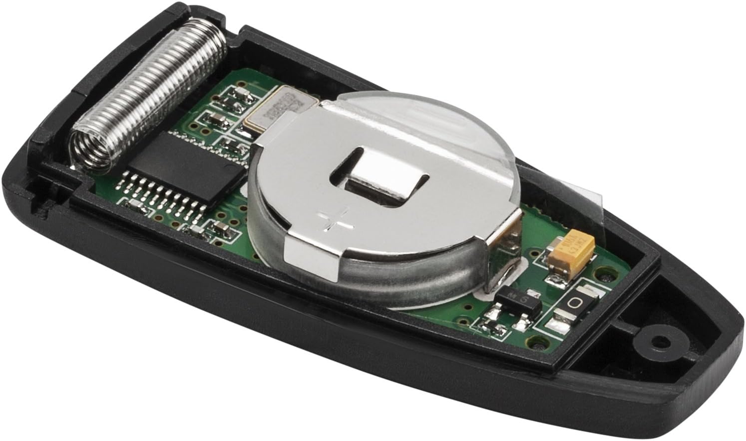 Inside view of the remote control, showing the circuit board and the coin-cell battery compartment.