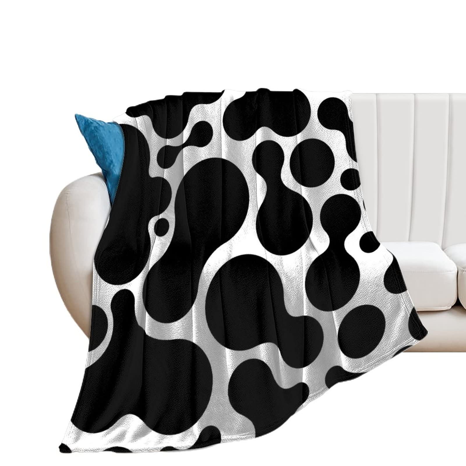 Couverture en flanelle chaude à motif tacheté pour vos soirées cocooning sur le canapé du salon