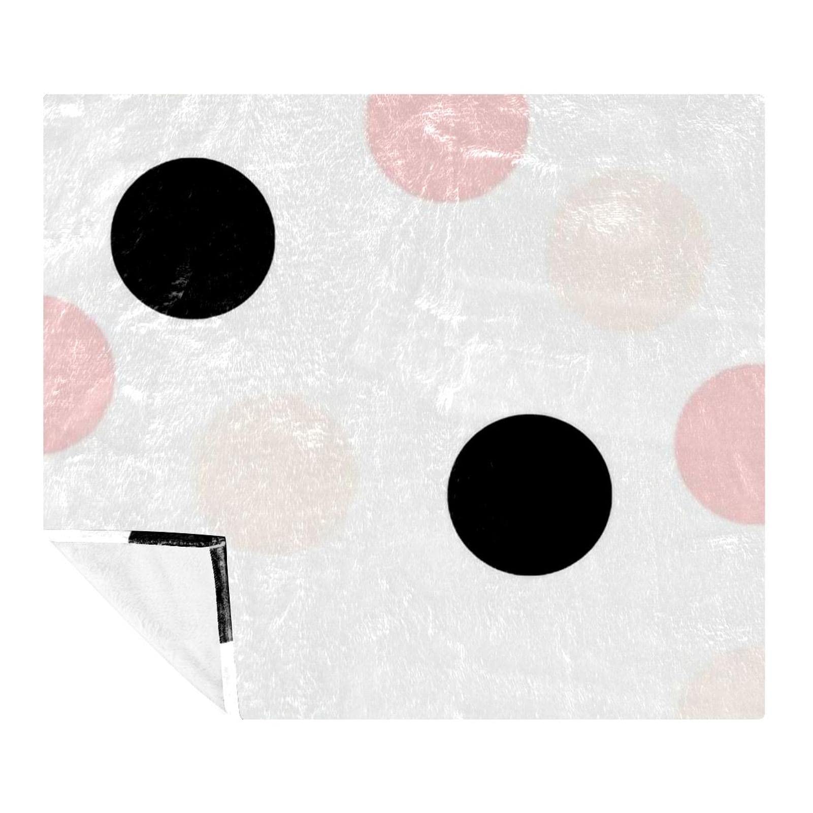 Couverture polaire noire à pois rose pour réchauffer l'ambiance de la maison