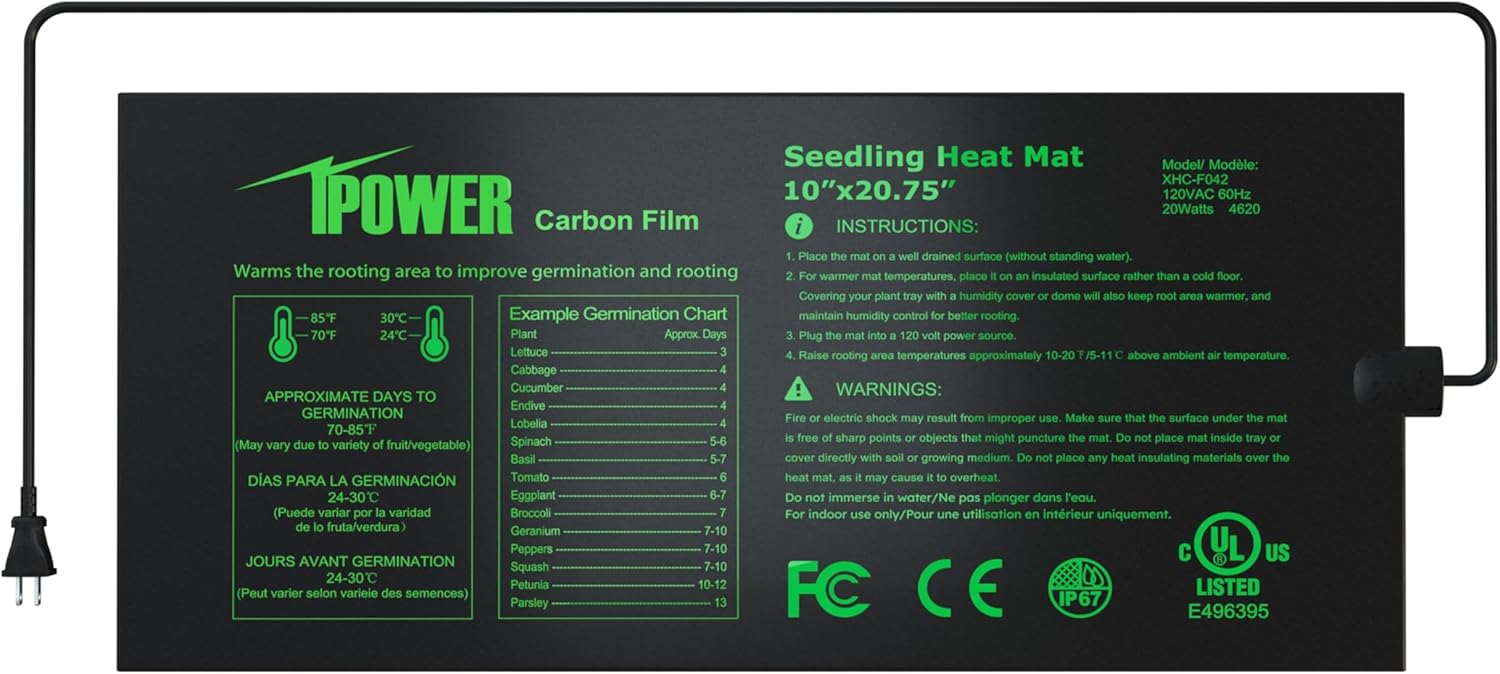 A seedling heat mat with several peat pots containing young sprouts on top of it.