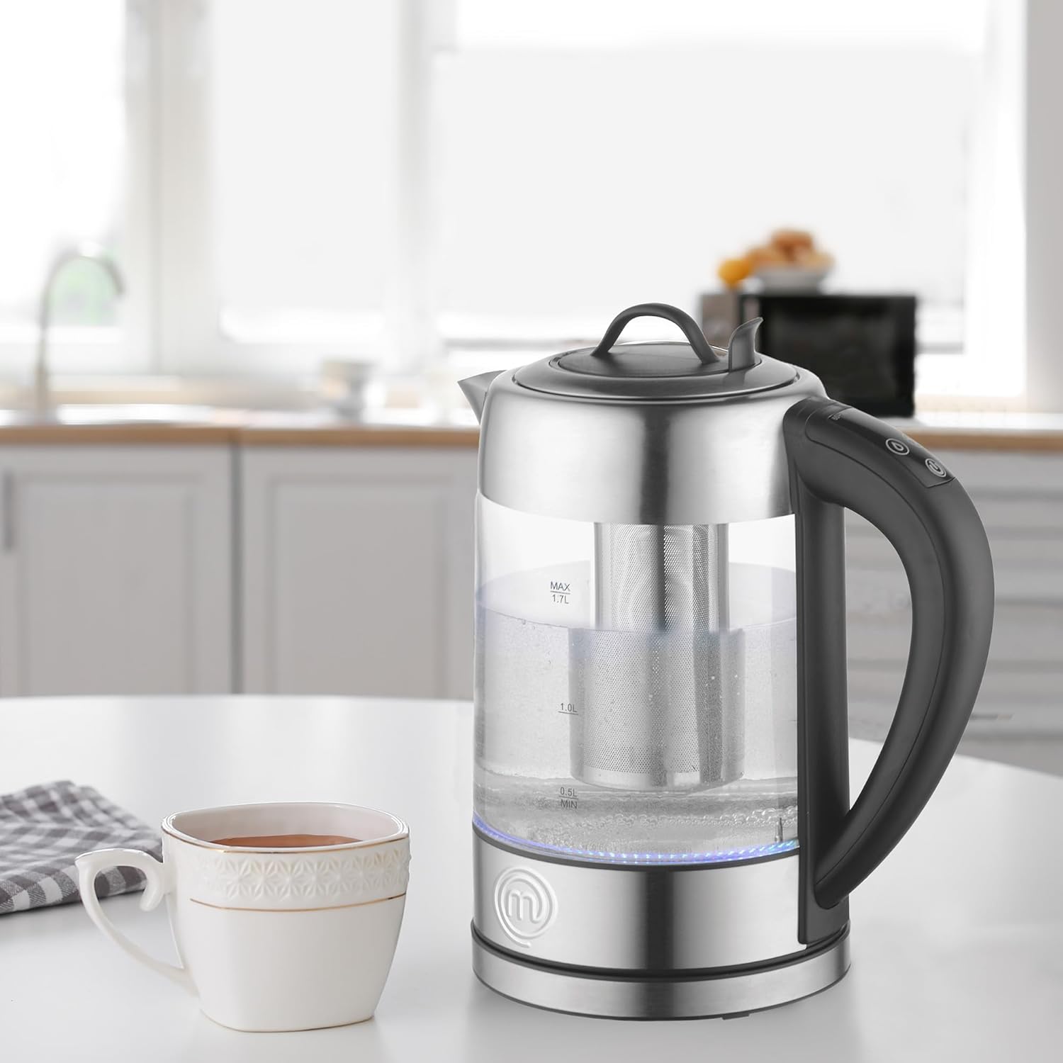 Electric kettle filled with water, showing water level markings.