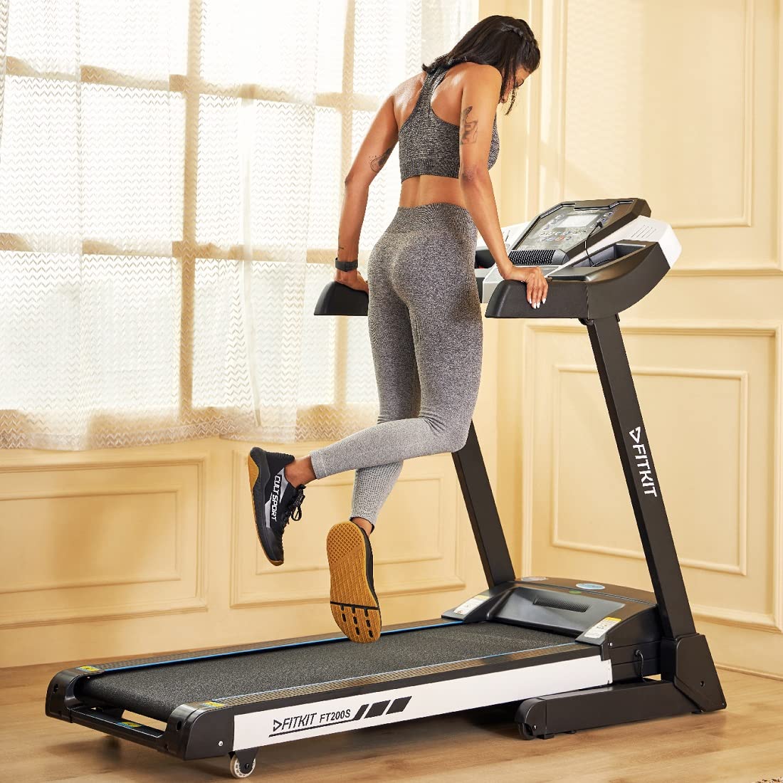 User exercising on the Fitkit FT200S Treadmill, demonstrating proper posture and use.