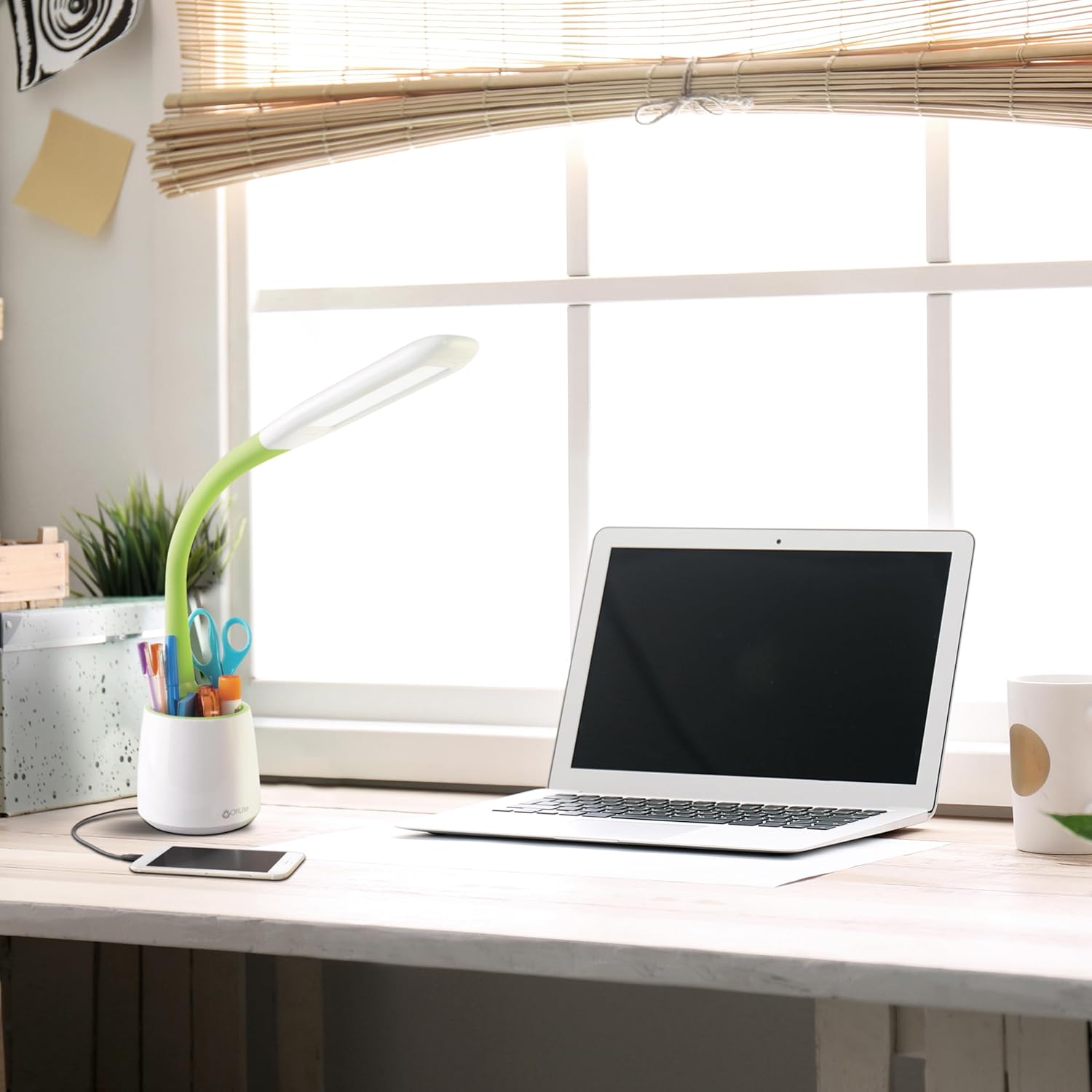 OttLite Organize LED Desk Lamp on a wooden desk next to a laptop and a smartphone charging via the lamp's USB-port.