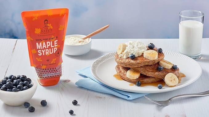 Nate's Honey Maple Syrup is a delectable, eco-friendly topping that enhances the flavors of waffles and pancakes. Packaged conveniently in a 10.75 oz sustainable pouch, this syrup stands out from the crowd with its authentic blend of pure honey and real maple syrup.