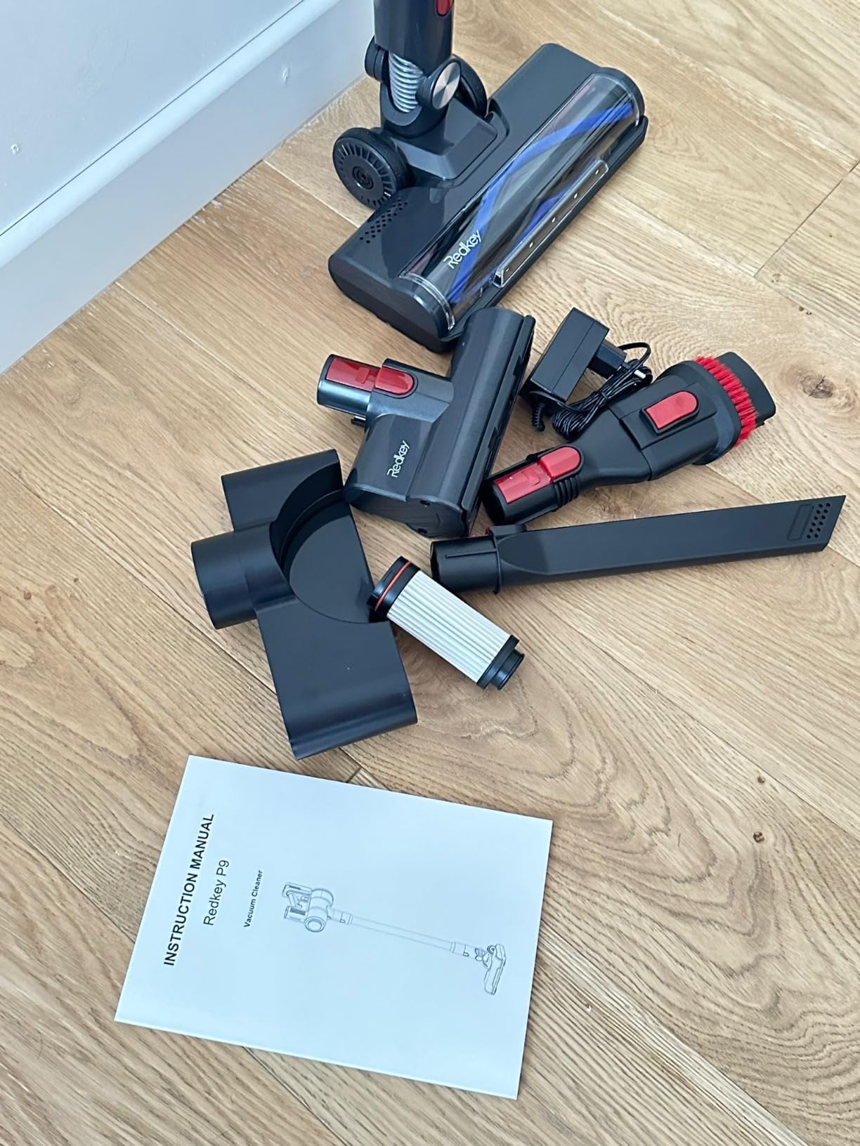 Redkey P9 Cordless Vacuum Cleaner showing the removable battery and charging