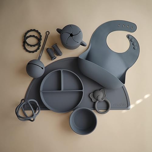 Miniatura 3 de Mushie - Babero de silicón para bebé, ajustable y resistente al agua (vientos alisios del oeste)