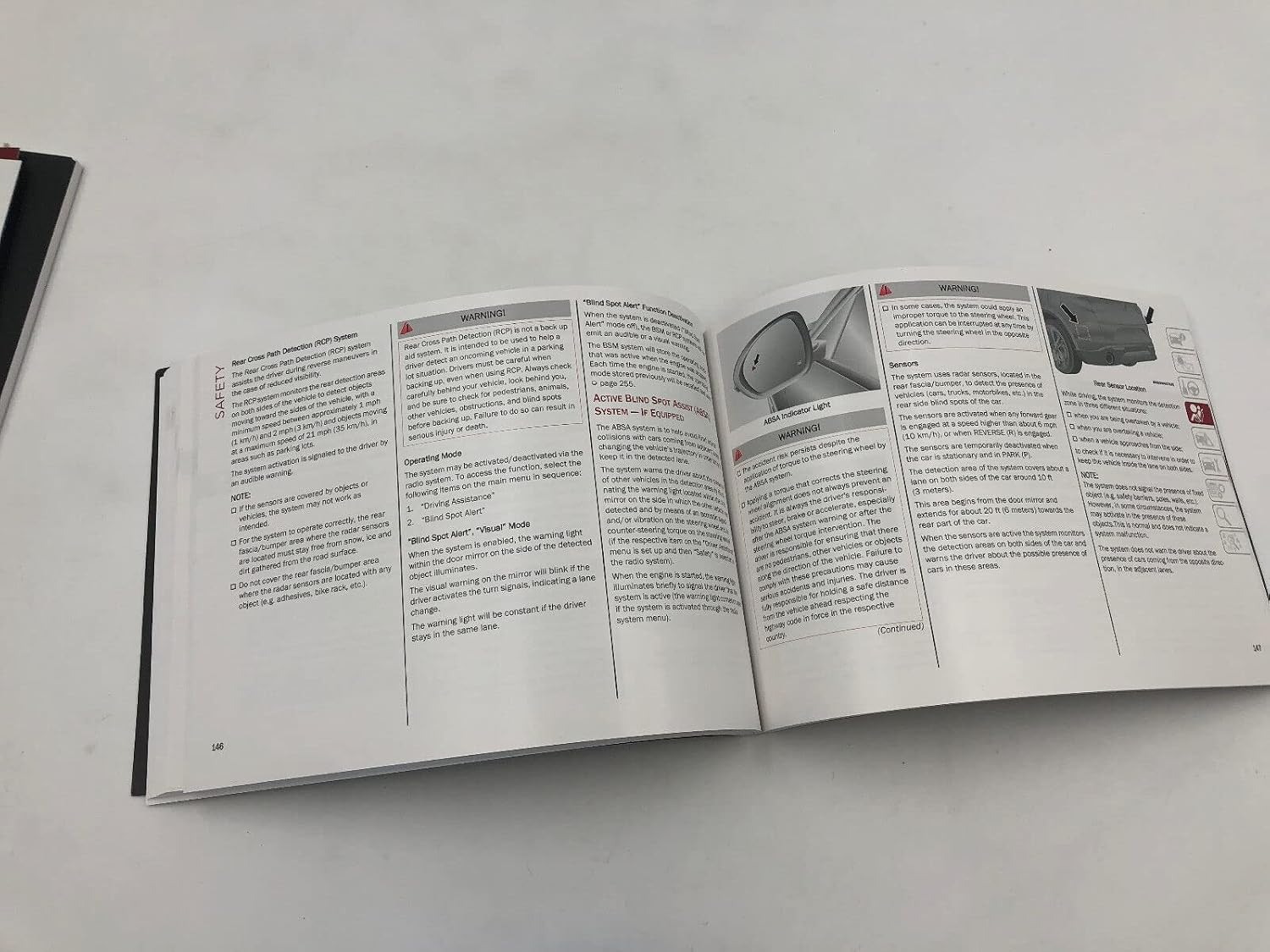 Page from the owner's manual showing Rear Cross Path Detection and Blind Spot Alert
