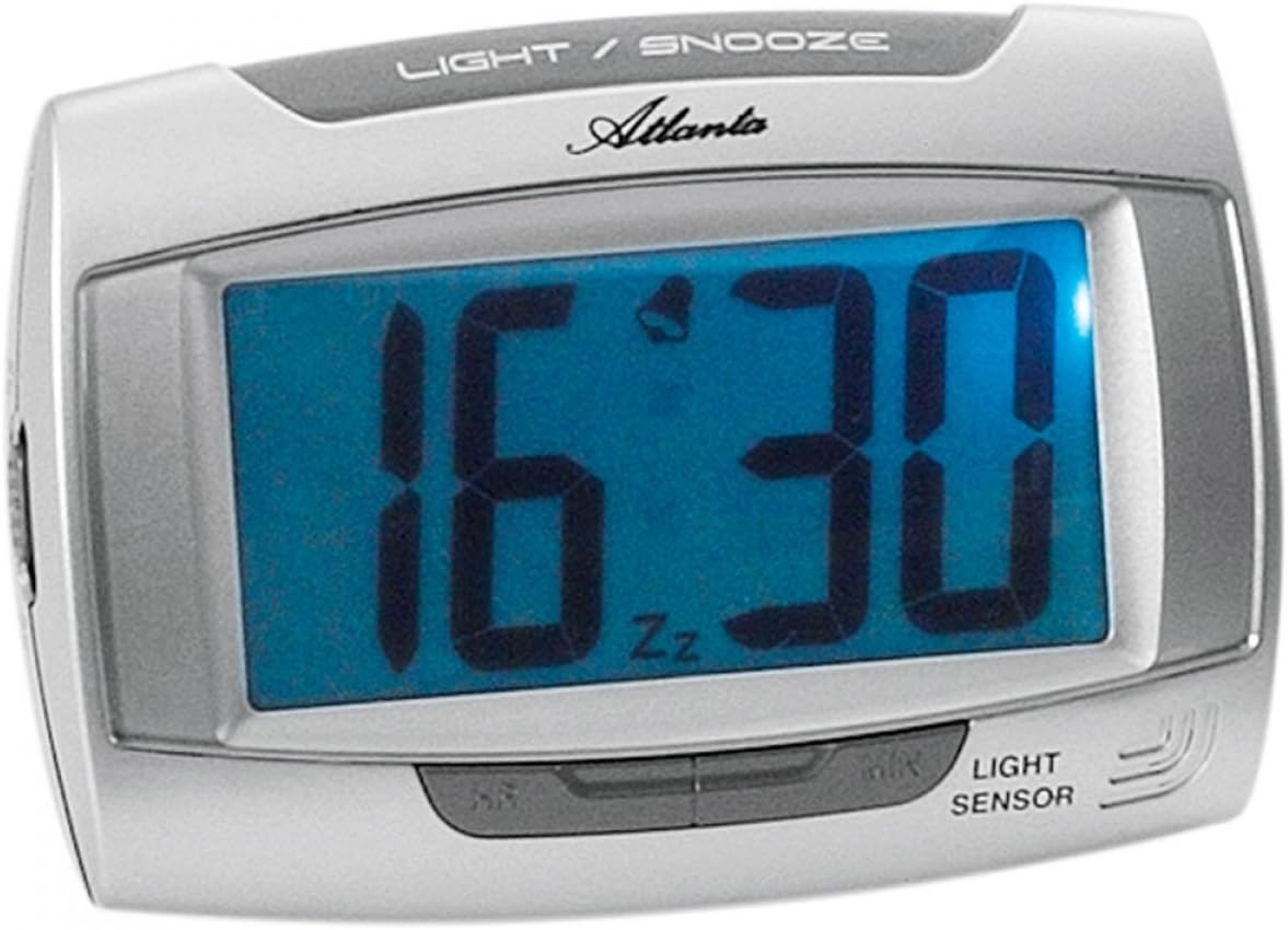 Atlanta 1669/19 Quartz Alarm Clock with digital display showing 16:30, a bell icon, and 'Zz' for snooze. The clock is silver-colored with a blue display.