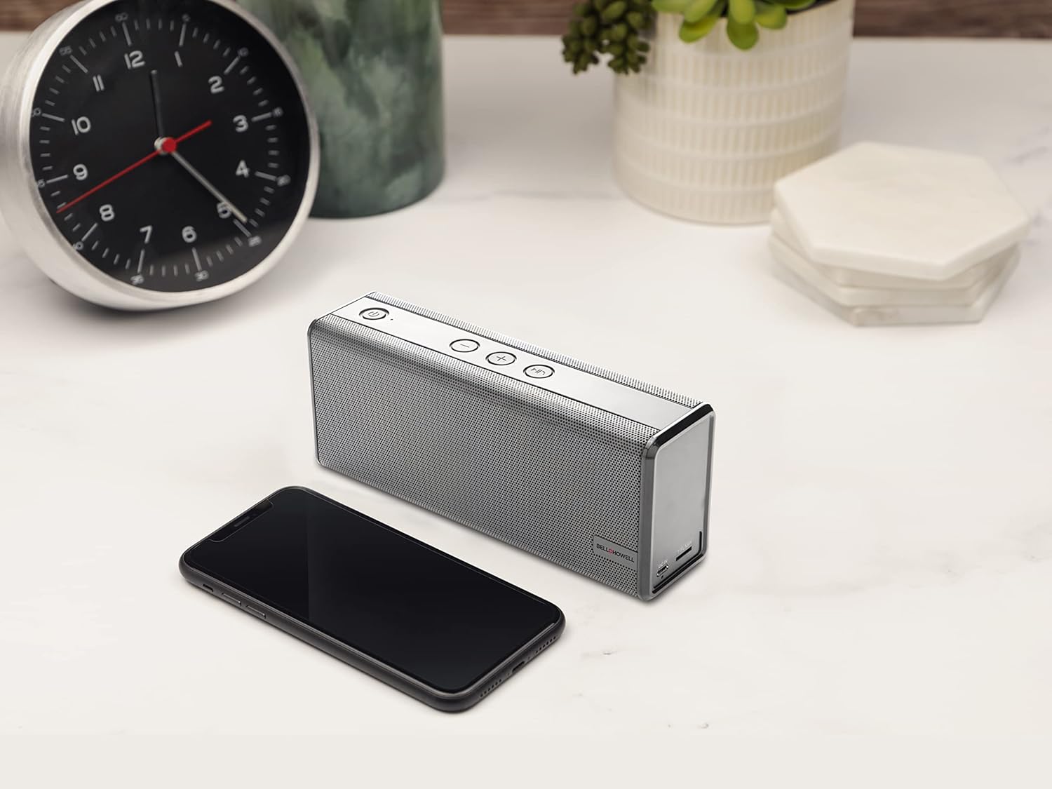 Bell+Howell BH65TWS speaker next to a smartphone on a desk