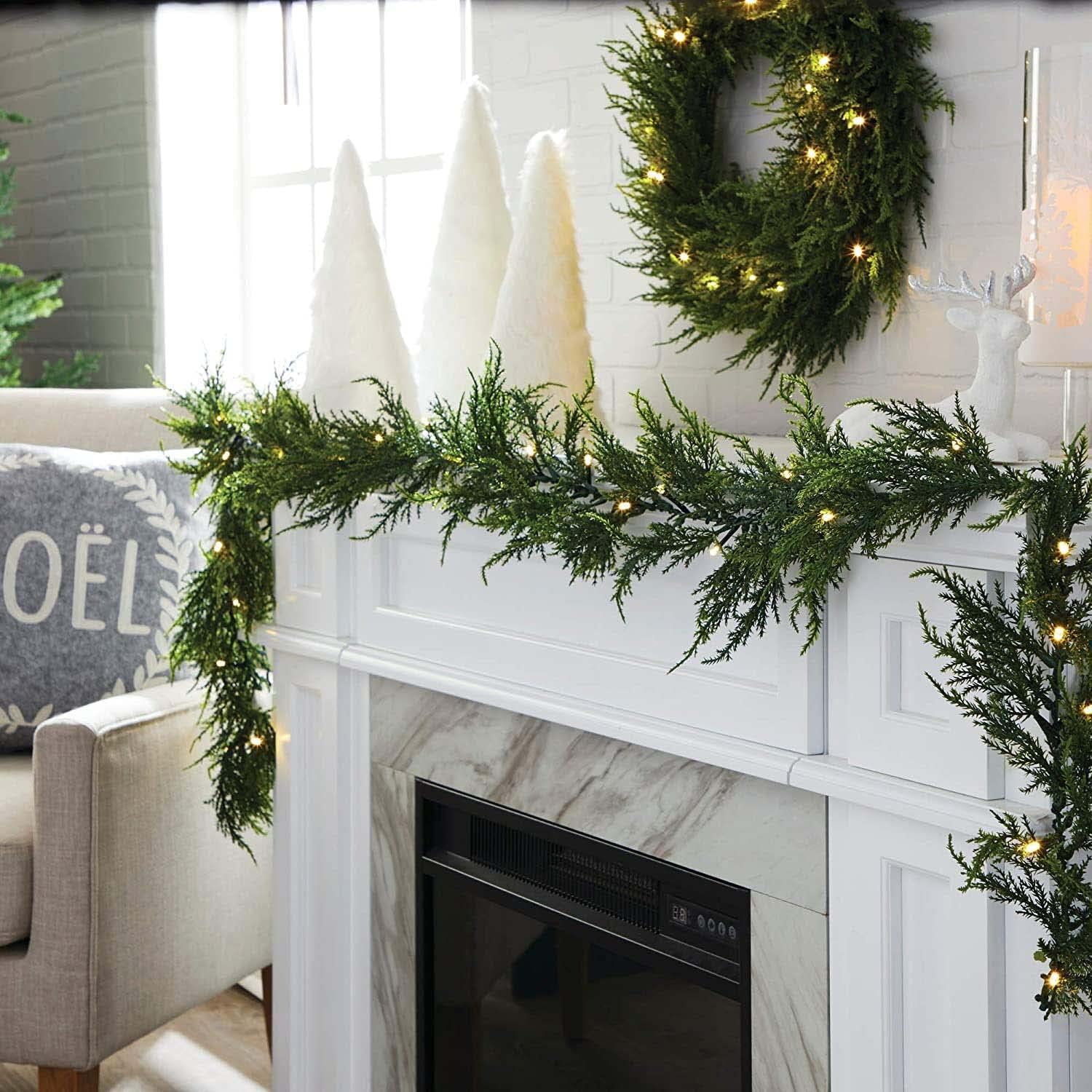 Noma 9-Ft LED Cedar Christmas Garland extending from a mantelpiece into a living space