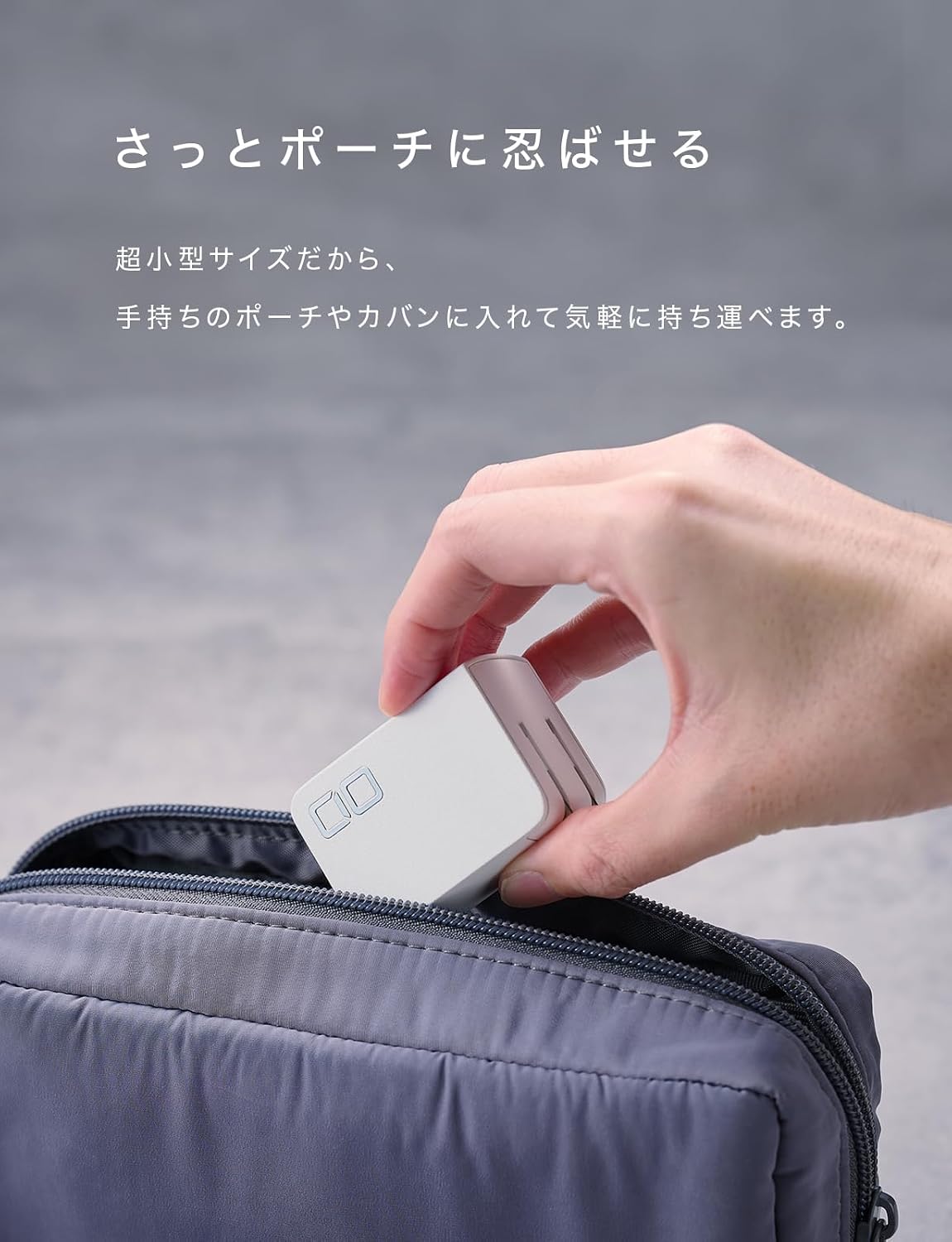 Hand placing CIO NovaPort TRIO II charger into a small pouch