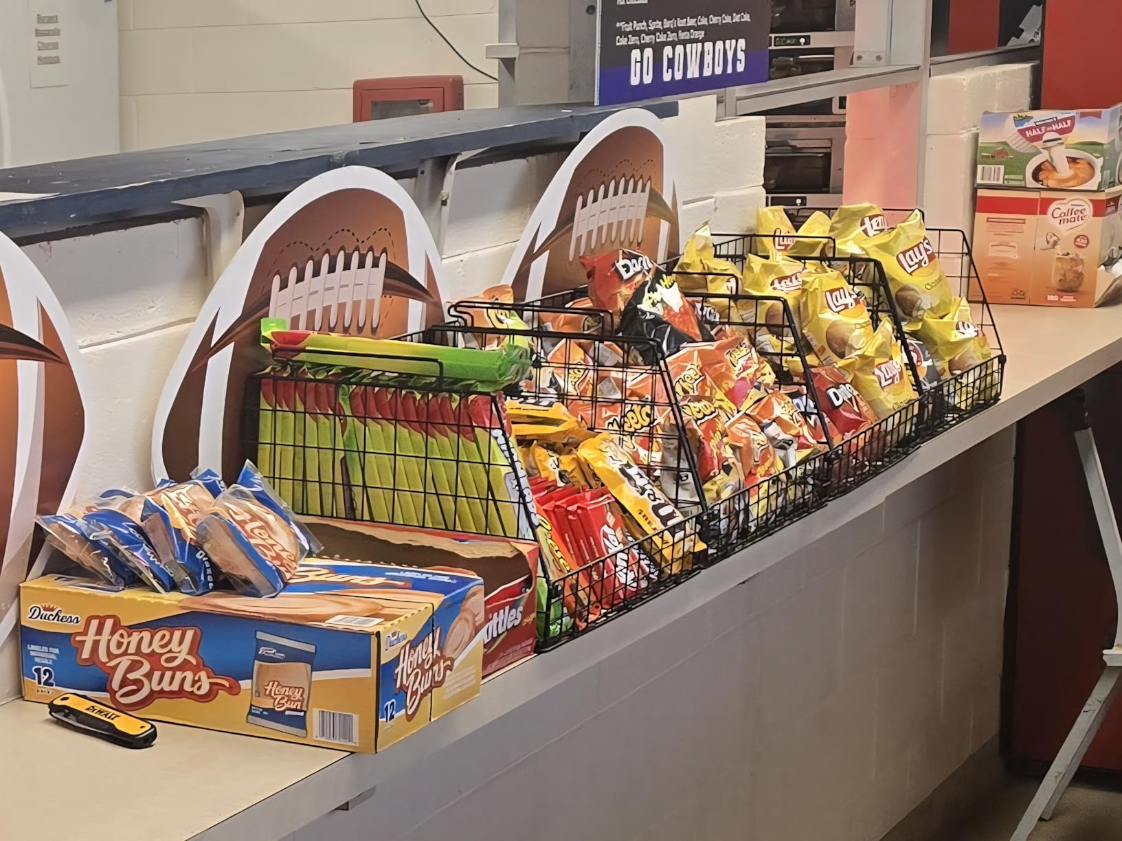 Wire storage baskets stacked in a pantry holding snacks