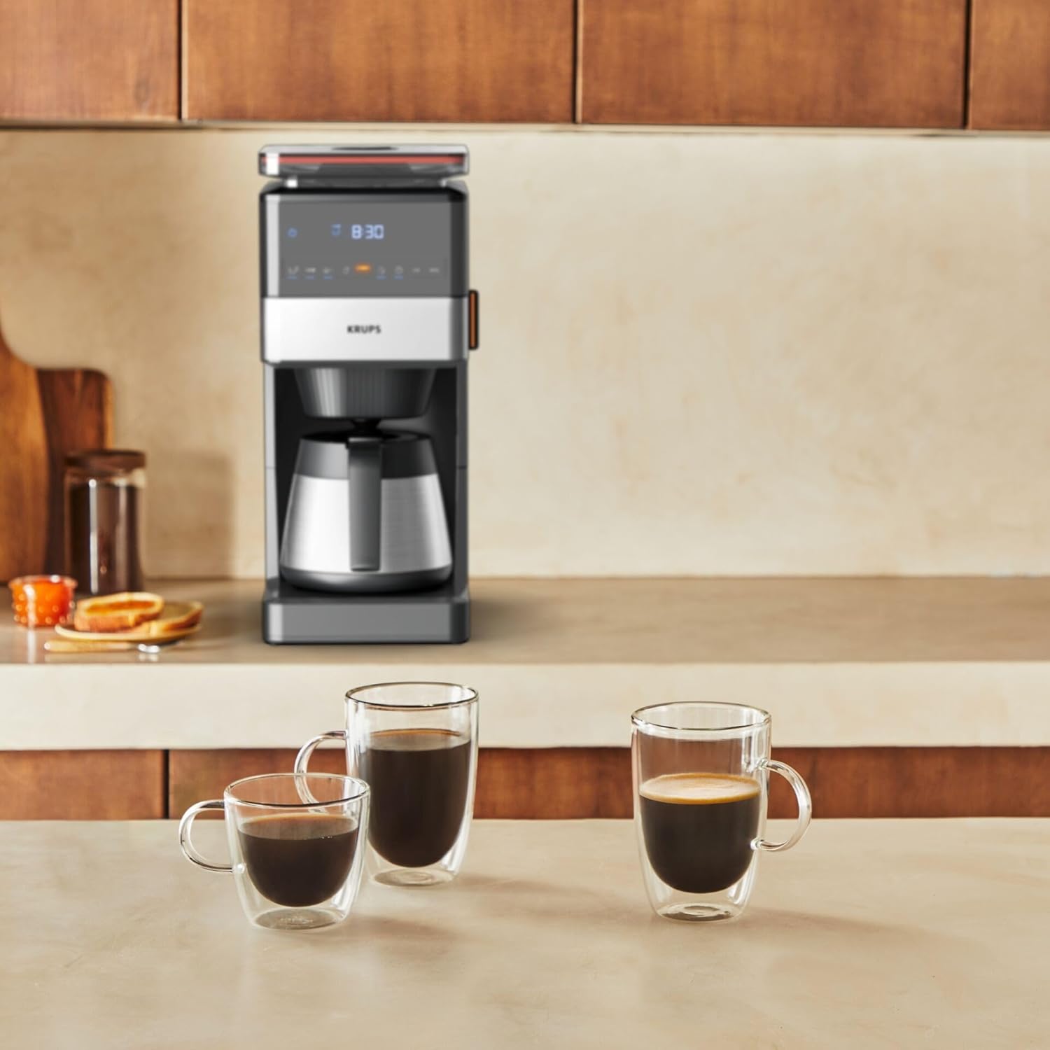 KRUPS Grind Aroma XL KT842810 coffee machine brewing coffee on a kitchen counter with cups