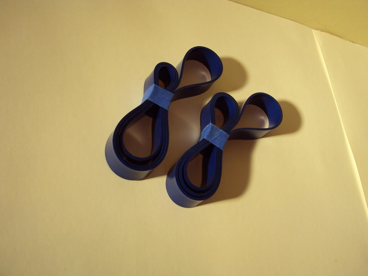 Two coiled Workmas Blue Max urethane band saw tires