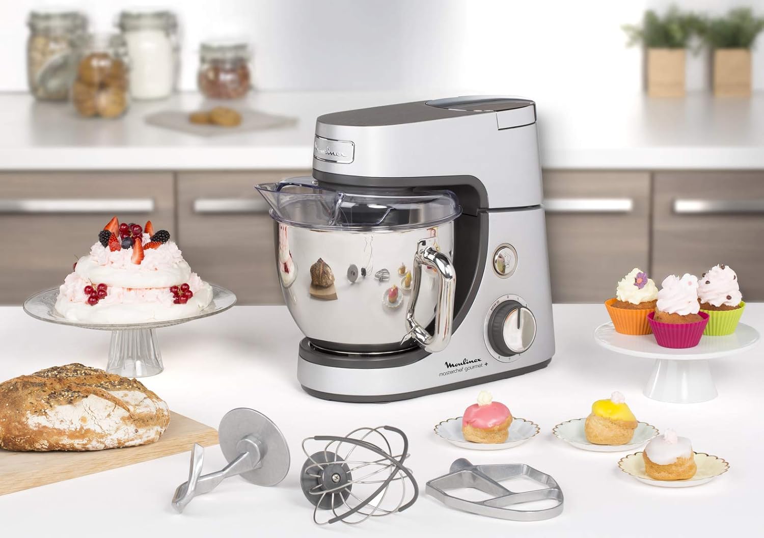 Moulinex Masterchef Gourmet+ Kitchen Machine with various baked goods and attachments