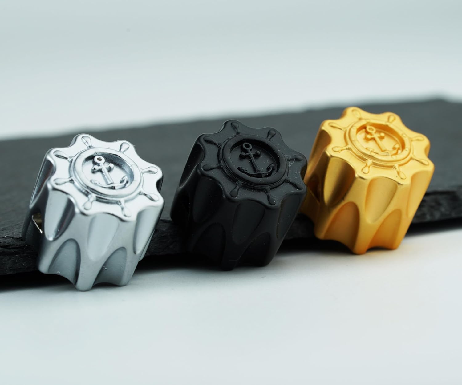 Three Guyker CKB035 dome potentiometer control knobs in silver, black, and gold finishes, arranged on a dark surface.