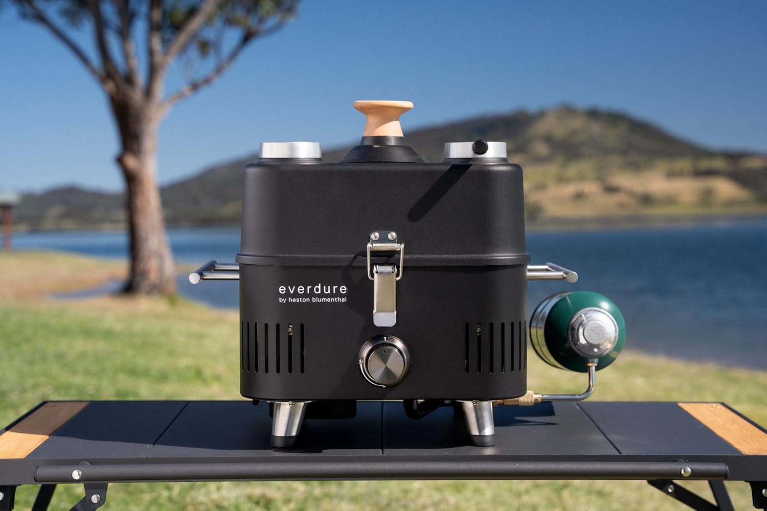 Everdure CUBE Proflame 360 grill set up outdoors with propane tank