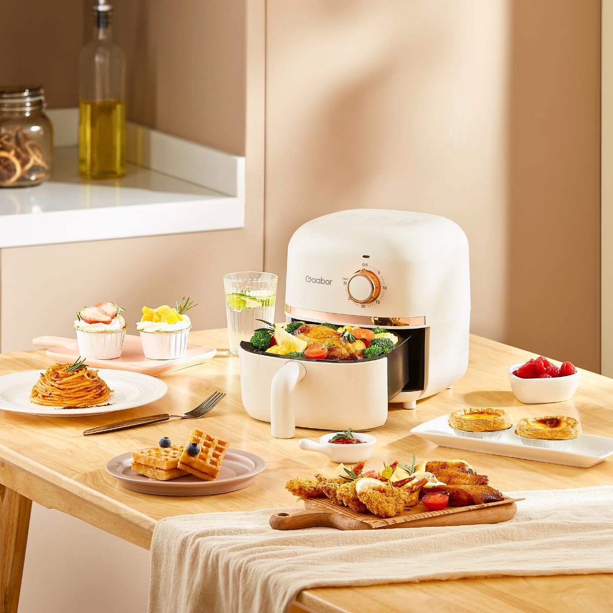 Hand pulling out air fryer basket filled with cooked chicken and vegetables