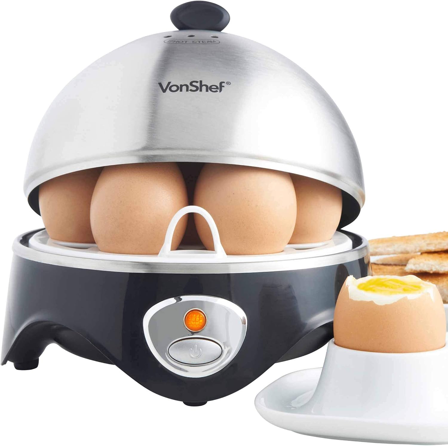 A soft-boiled egg in an egg cup with the top removed, showing a runny yolk, next to the VonShef egg cooker.