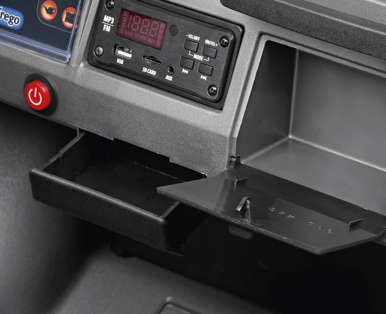 Close-up of the dashboard of the Peg Perego Gaucho PRO Realtree, showing the FM radio, USB port, SD card slot, AUX input, and start button.