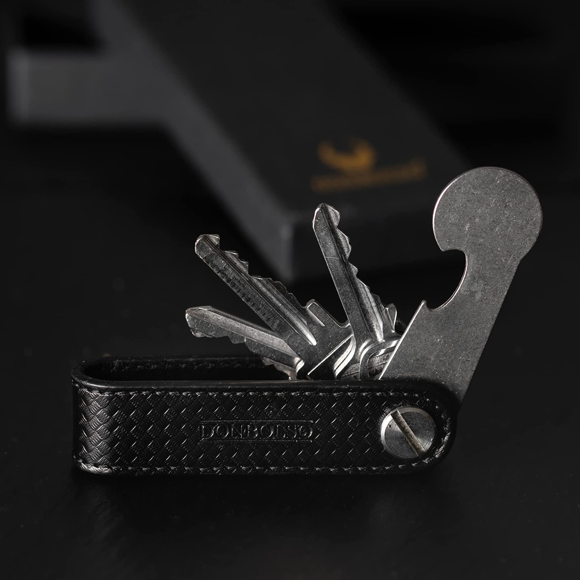 DONBOLSO Llavero One | Organizador Llaves con Liberación de Carro de la Compra | Porta Llaves para 1-7 Llaves | Tornillo de Acero Inoxidable | Carbono y Napa Negro