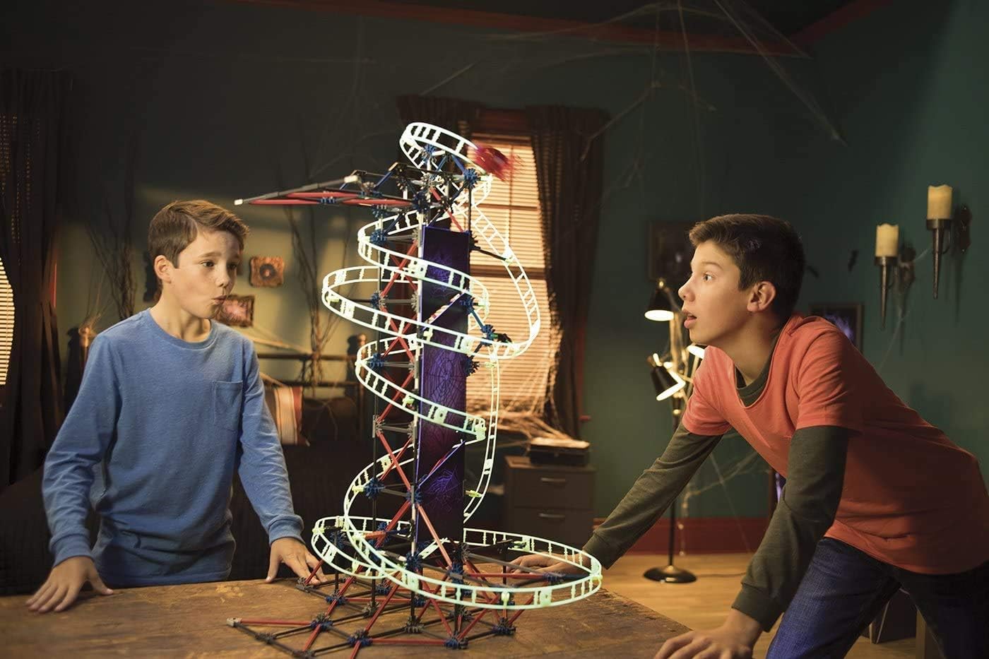 Two boys observing the assembled K'NEX Web Weaver Roller Coaster.