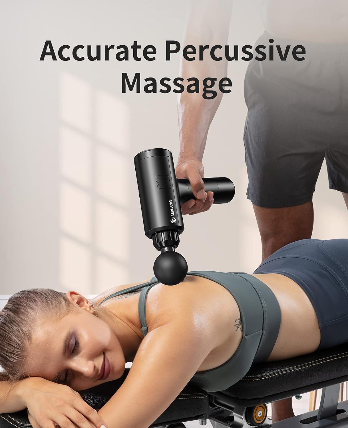 Person using the AERLANG Massager Gun on their back for percussive massage