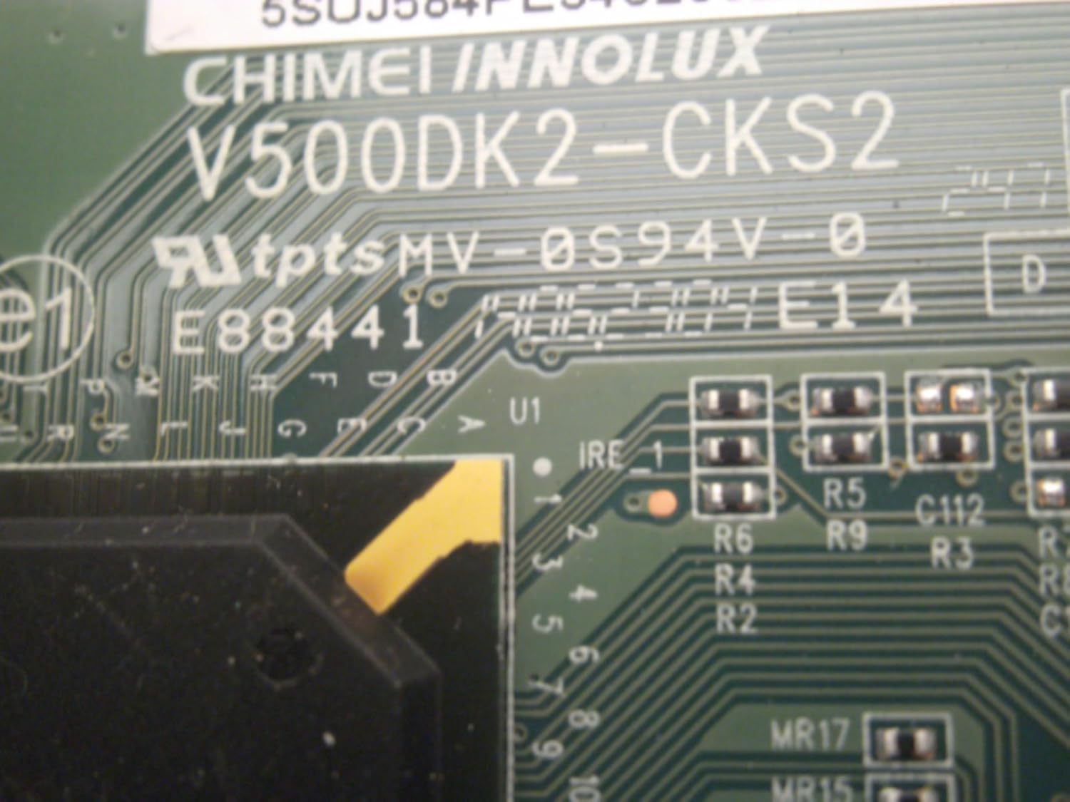 Detailed view of T-CON board components and part numbers