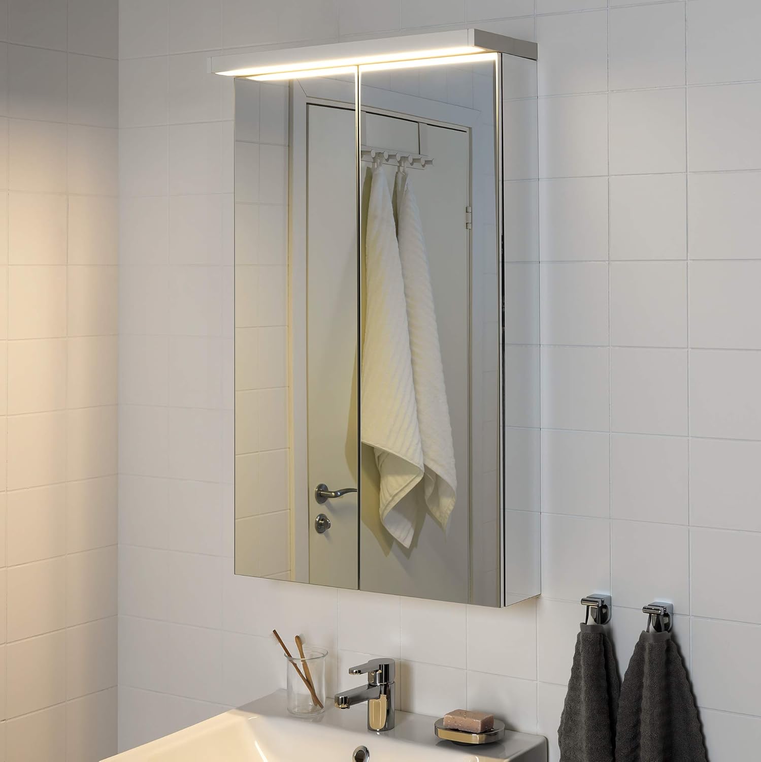 GODMORGON LED Wall Lamp installed above a mirror cabinet
