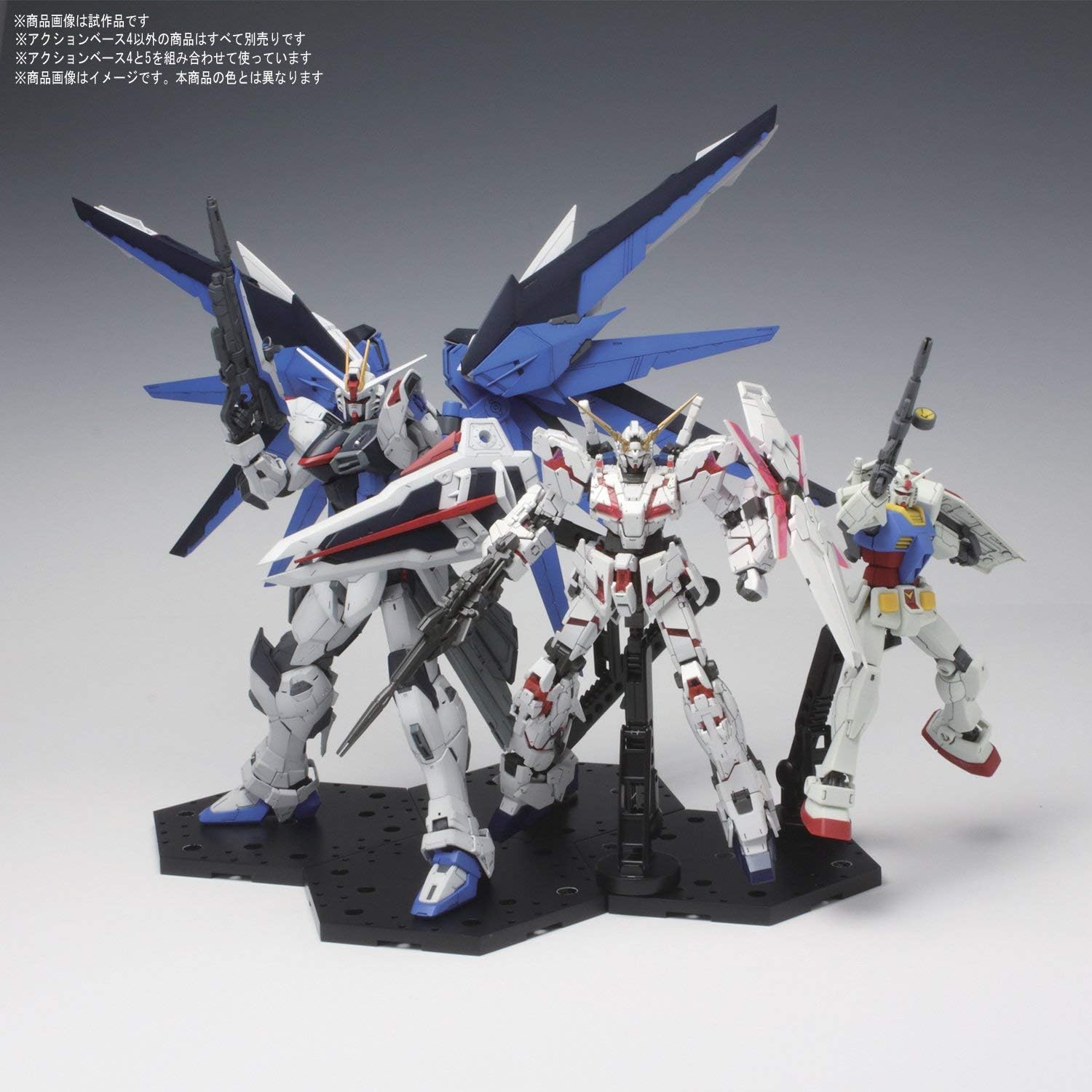 Three model kits displayed together on a combined Bandai Hobby Action Base 4 setup.