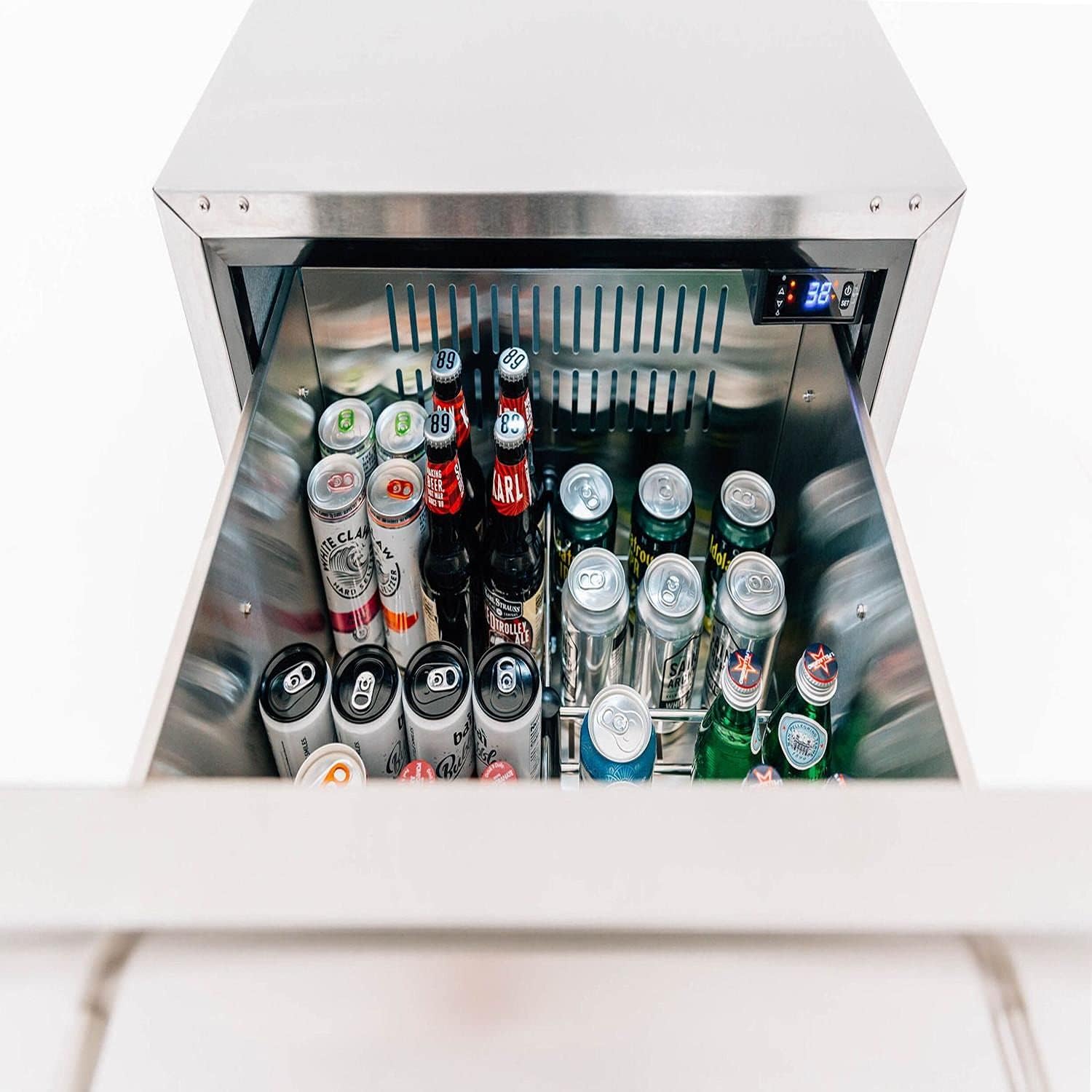 Summerset SSRFR-24DR2 outdoor refrigerator installed flush within an outdoor kitchen cabinet, showing its stainless steel exterior and two drawers.