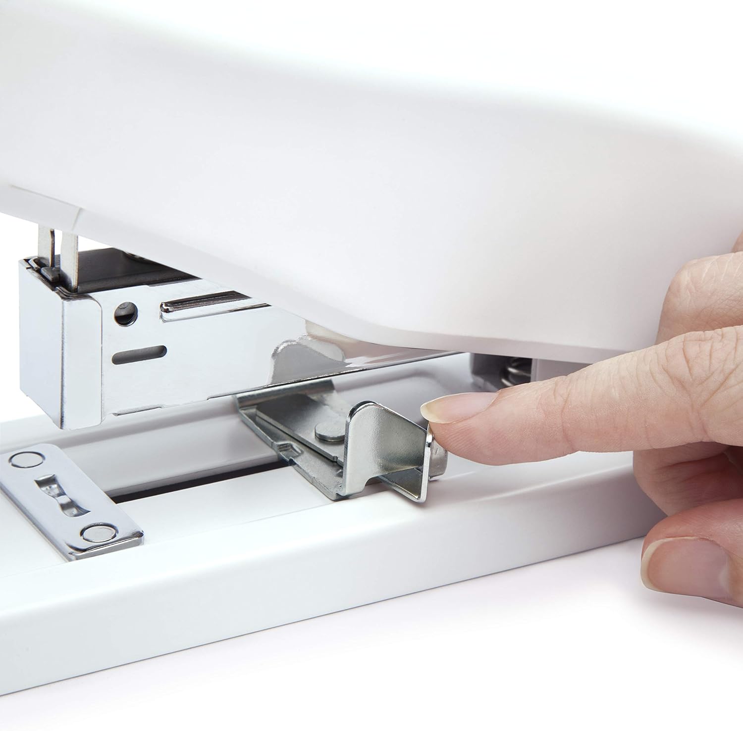 A finger adjusting the metal paper guide on the base of the Rapesco heavy-duty stapler.