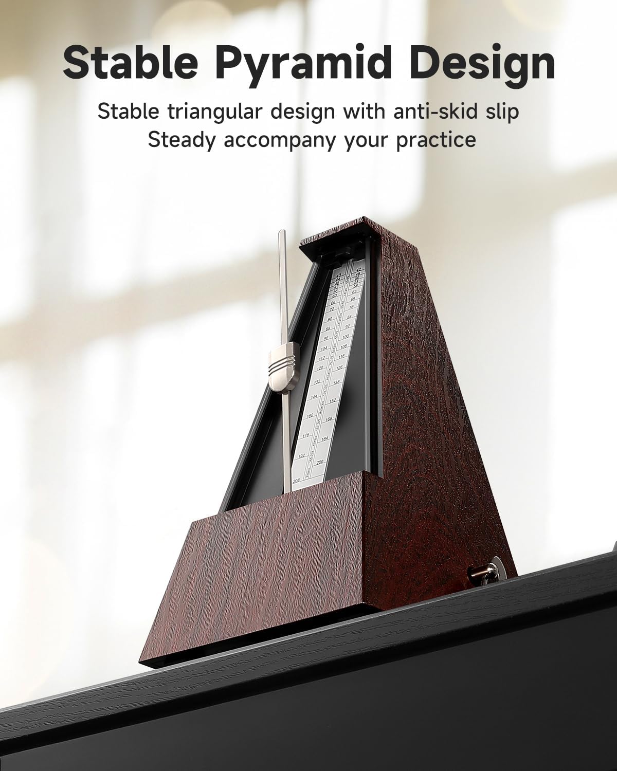 Donner DPM-1 metronome on a shelf, showcasing its stable pyramid design with anti-skid feet.