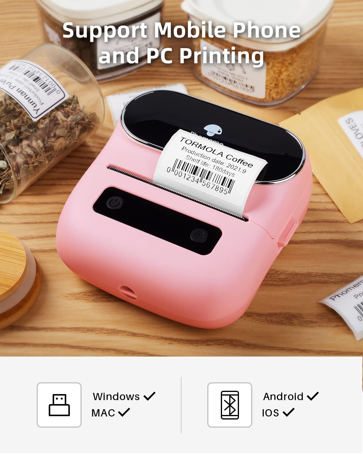 Phomemo M220 Label Maker on a wooden table, showing icons for Windows, MAC, Android, and iOS compatibility.