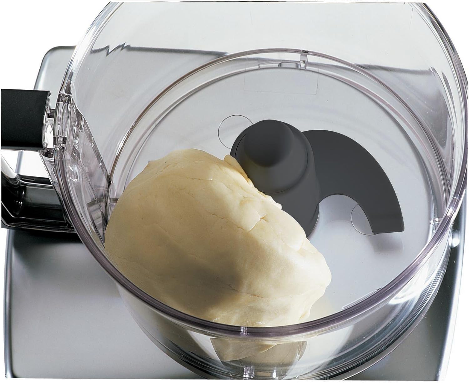 Close-up of the serrated main blade inside the food processor bowl.