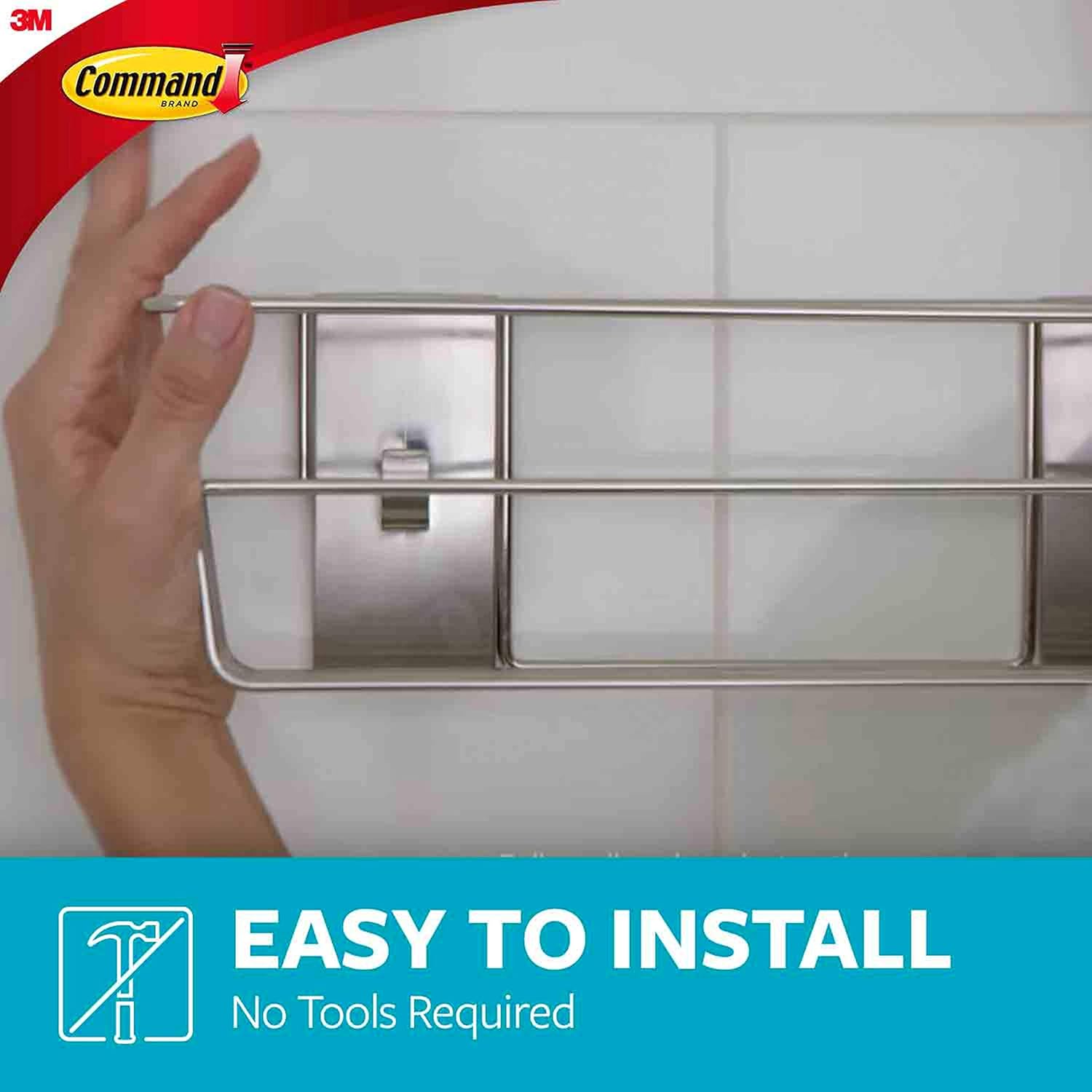 A hand demonstrating the easy, tool-free installation of the Command Shower Caddy.