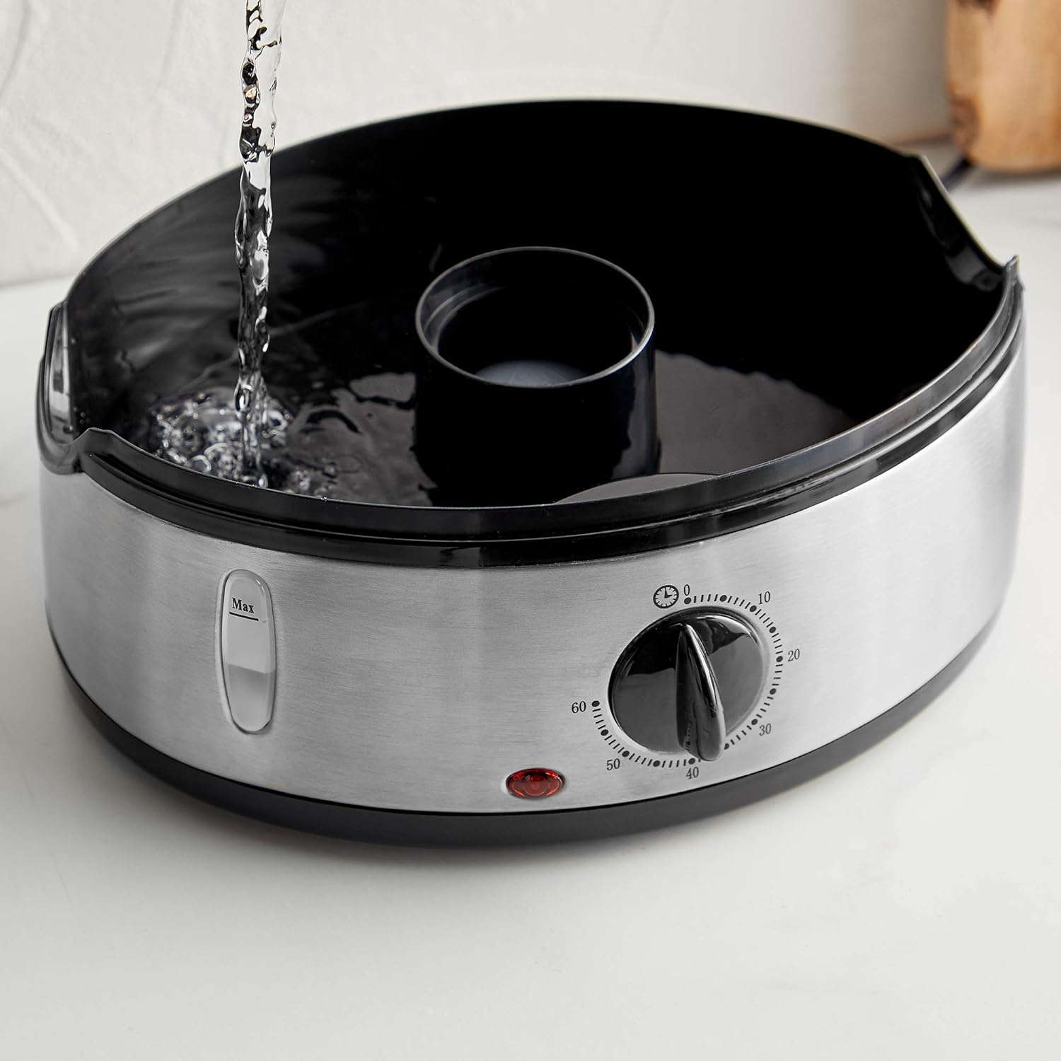 Water being poured into the water reservoir of the VonShef food steamer base.