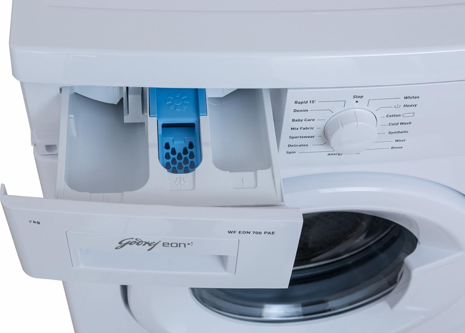 Detergent dispenser drawer of the washing machine pulled out, showing compartments for detergent and softener.