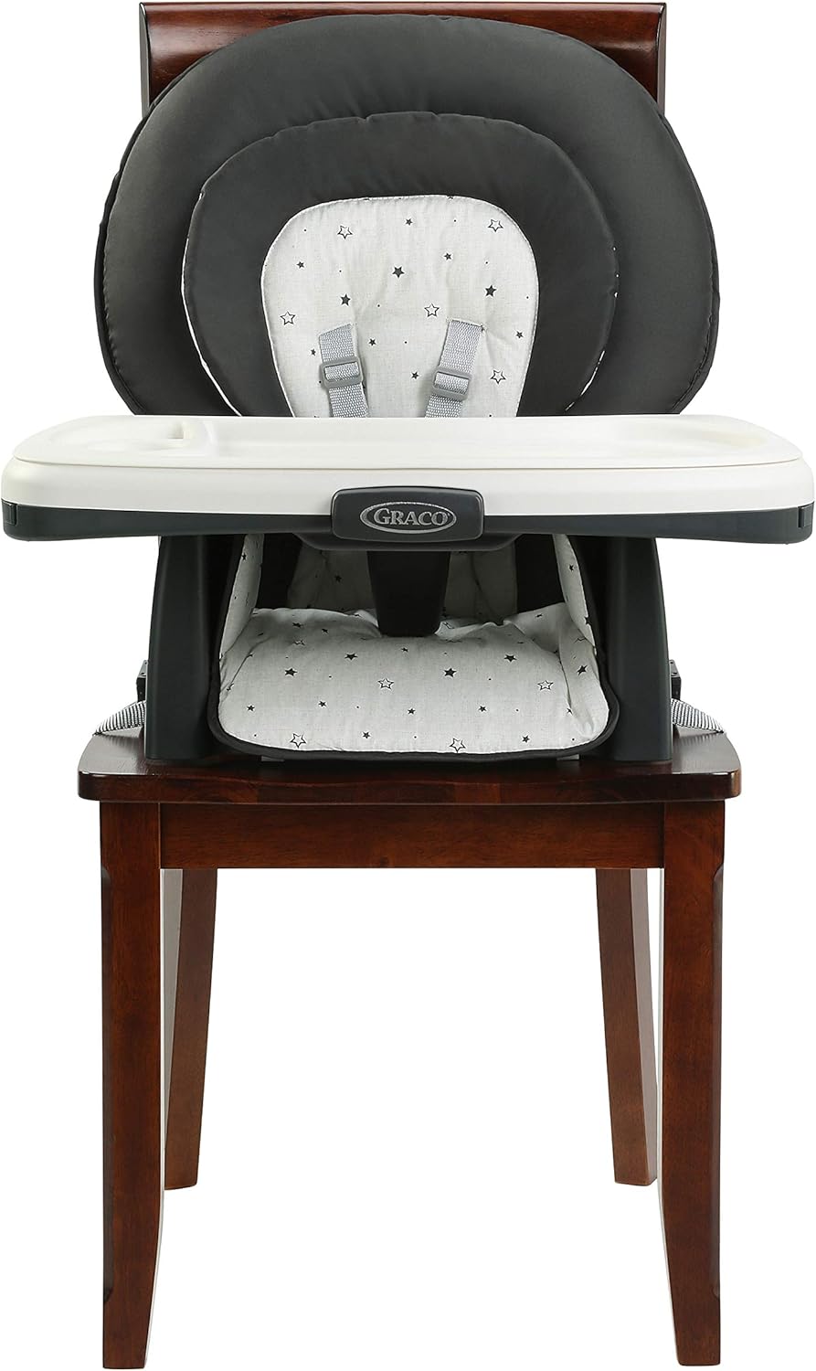 Booster seat attached to a dining chair