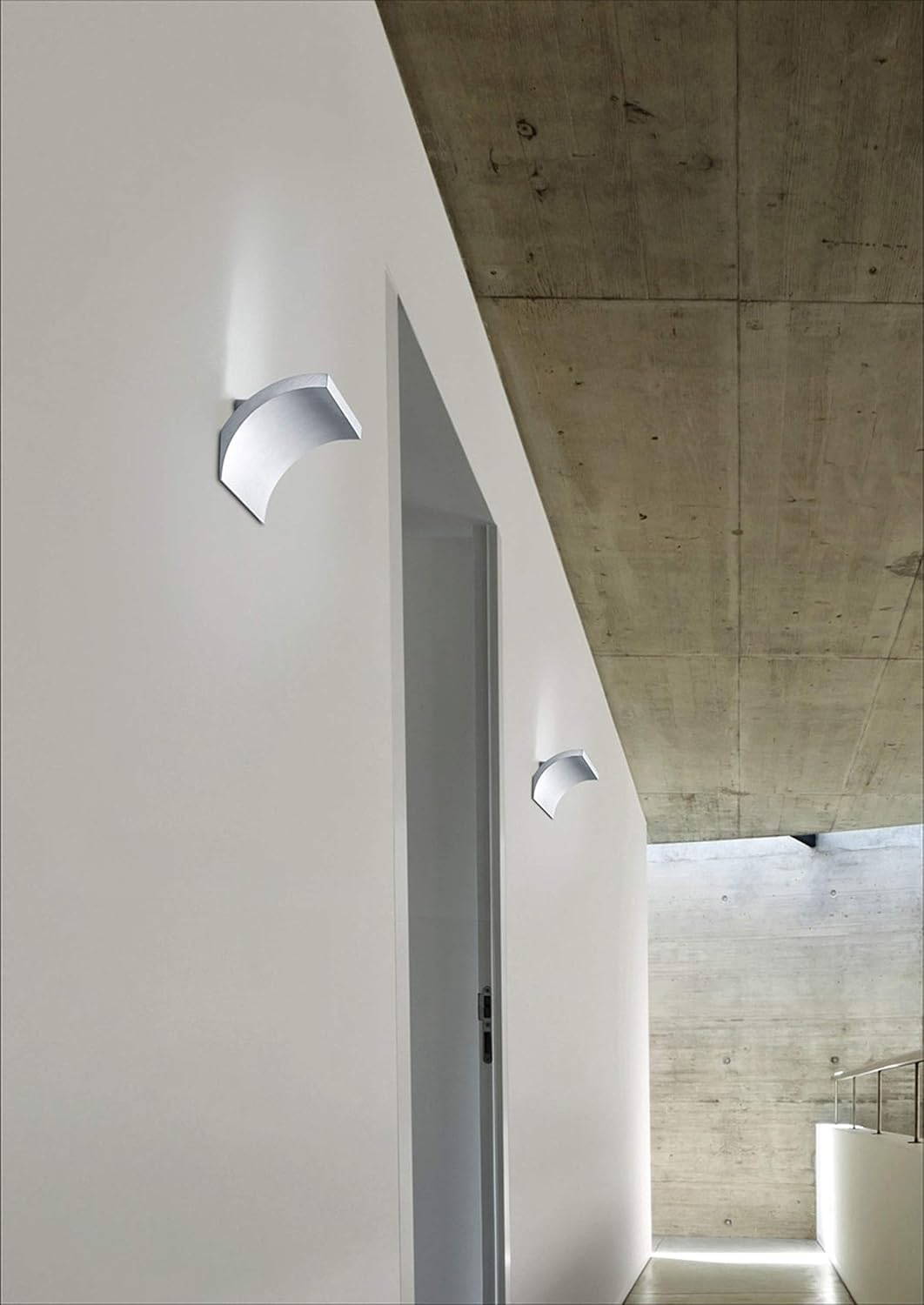 Two Helestra Adeo LED Wall Lights installed on a white wall in a modern interior, illuminating the space.