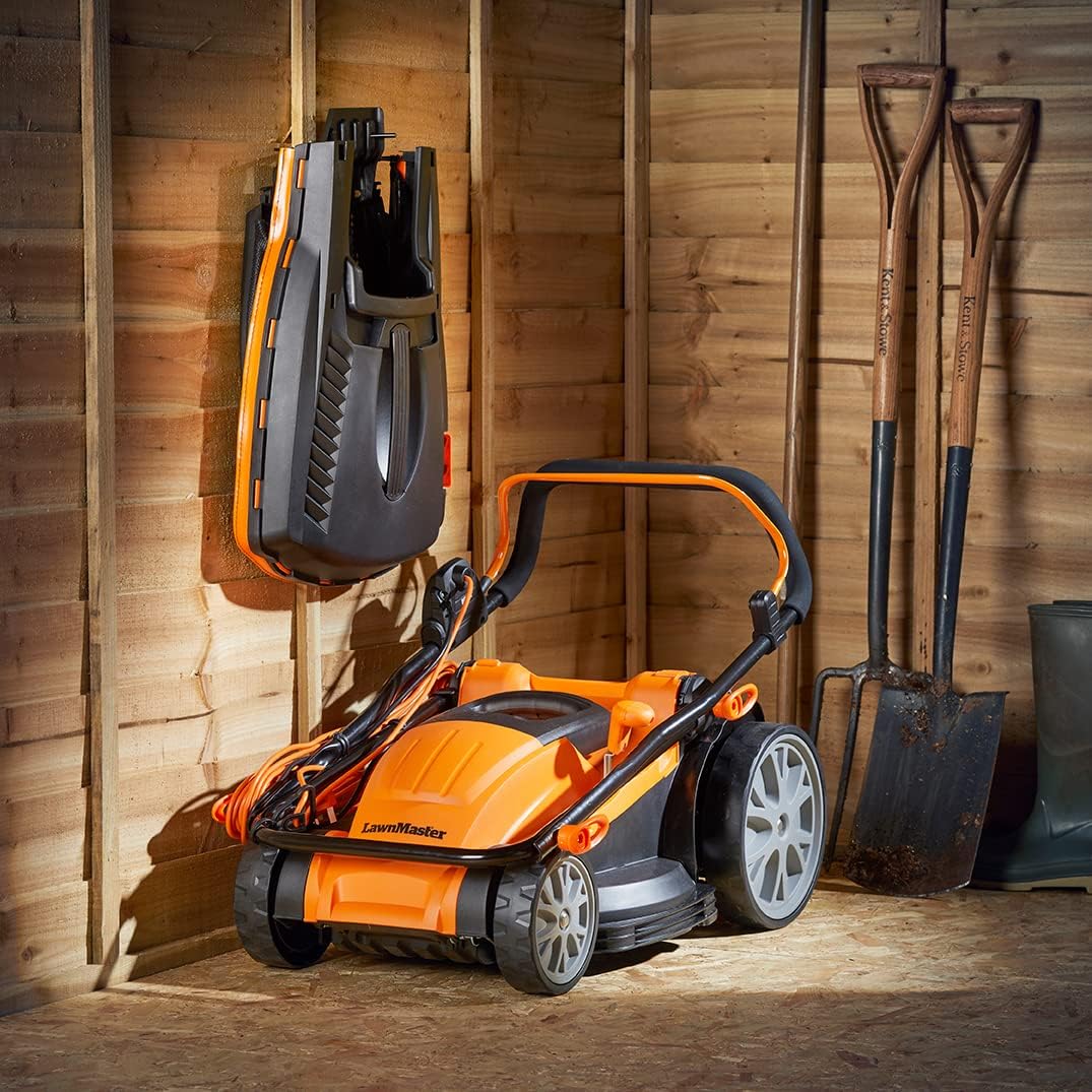 LawnMaster MEB1840M Electric Lawn Mower with folded handles, stored vertically against a wall