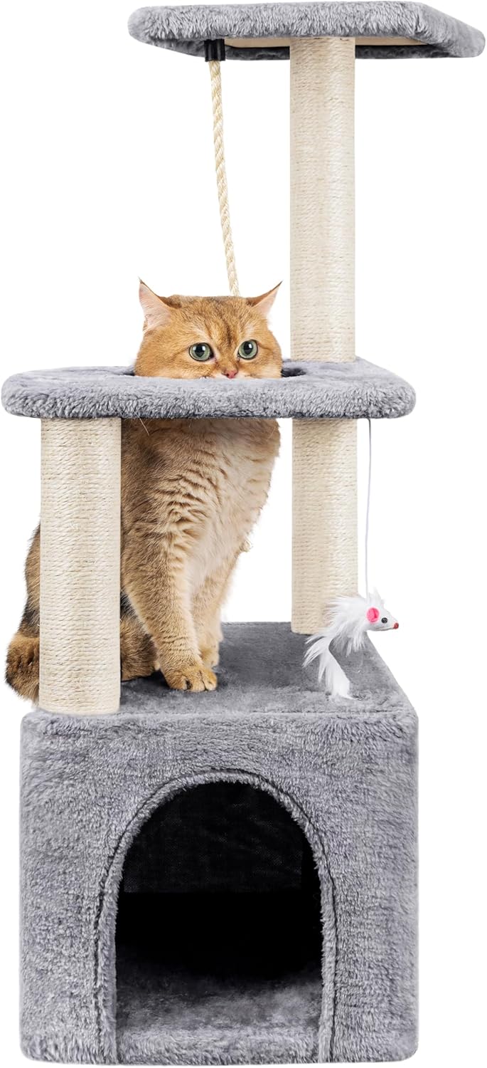 A golden-brown cat peeking out from the middle platform of the grey cat tree, with the cat house visible below.